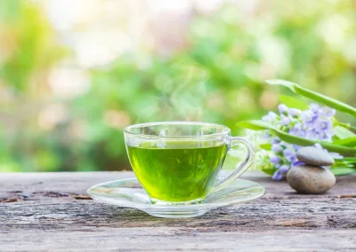 cups green tea wooden table